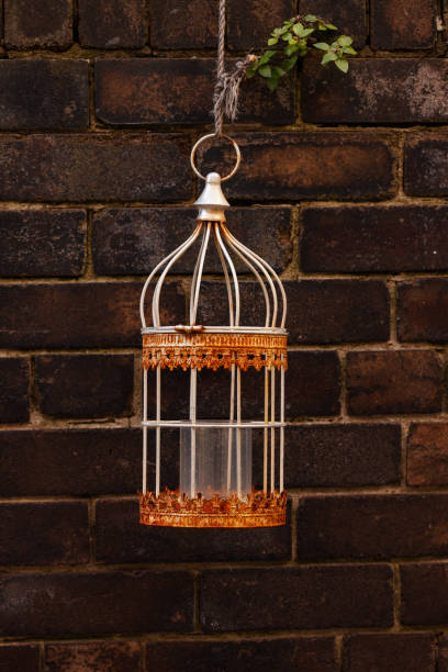 istock Ornate candle holder outside on a brick wall 1323279768