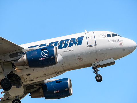 Bucharest, Romania - 05.14.2021: YR-ASD TAROM Airbus A318-111 airplane flying against clear blue sky. Close up detail.