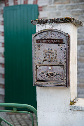 Close-up of an old mailbox on the outside wall of a house