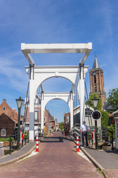 istock Bridge keeper watching over the historic white bridge in Loenen 1323290274