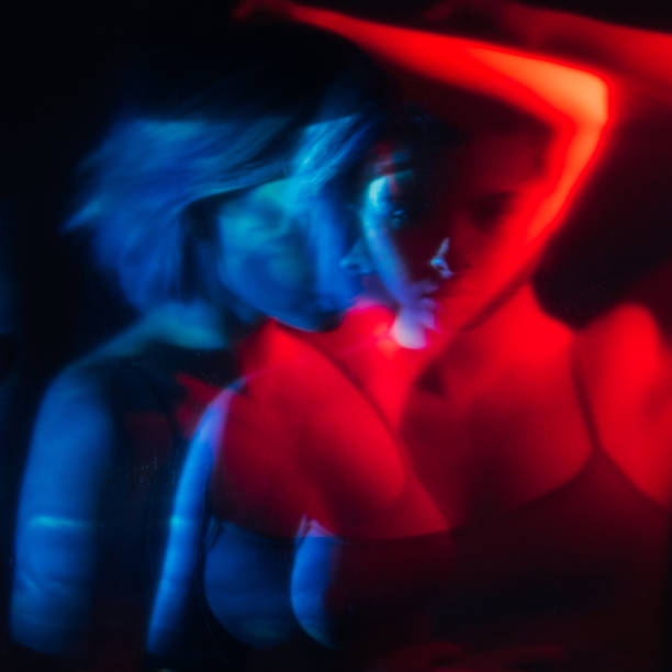 istock mental disorder defocused woman in red blue light 1323294969
