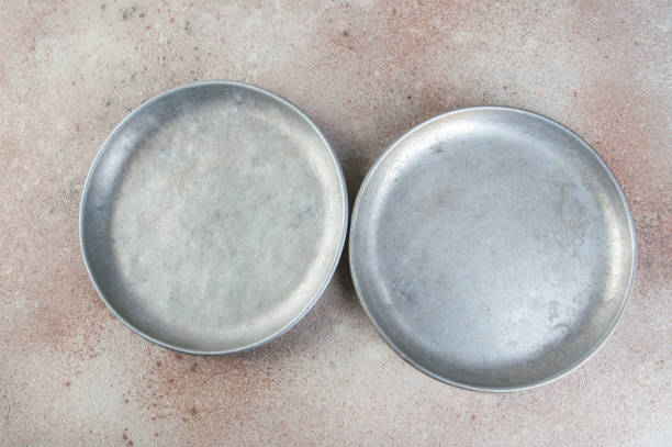 Old aluminum plates for scales on concrete background. Copy space for text.
