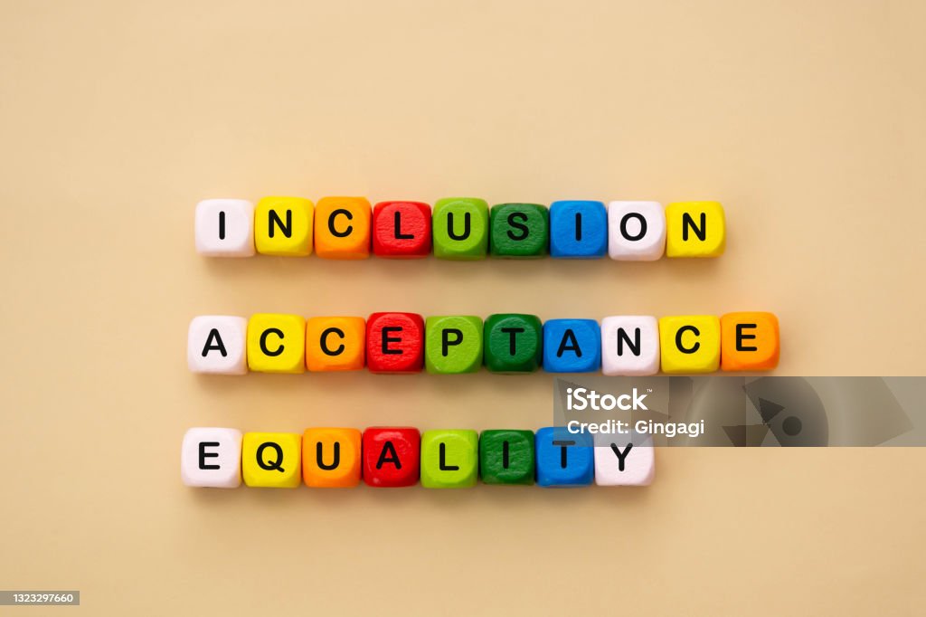 Inclusion, acceptance and equality words made from colorful wooden cubes. Inclusive and tolerance social concept, flat lay. Inclusion, acceptance and equality words made from colorful wooden cubes. Inclusive and tolerance social concept. LGBTQIA Rights Stock Photo