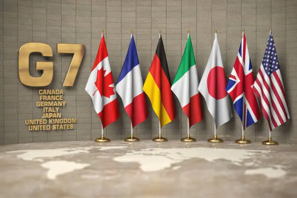Photo of G7 summit or meeting concept. Row from flags of members of G7 group of seven and list of countries