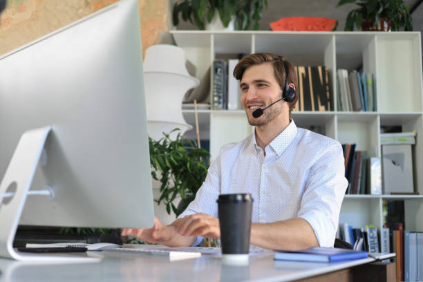 istock Smiling young business man having video call in office. 1323301868