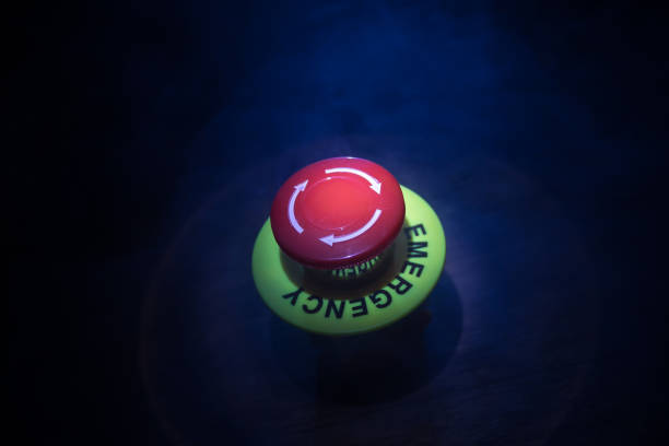 istock Emergency stop button, Disaster protection. Industrial concept. Red button on table in dark low key background. 1323302761