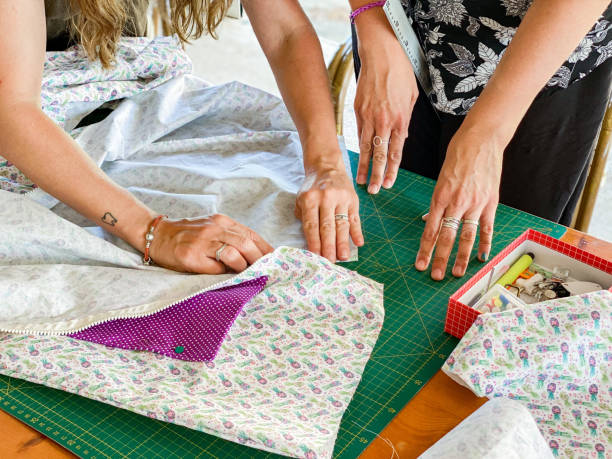 istock women on the terrace sewing with sewing machines 1323302863