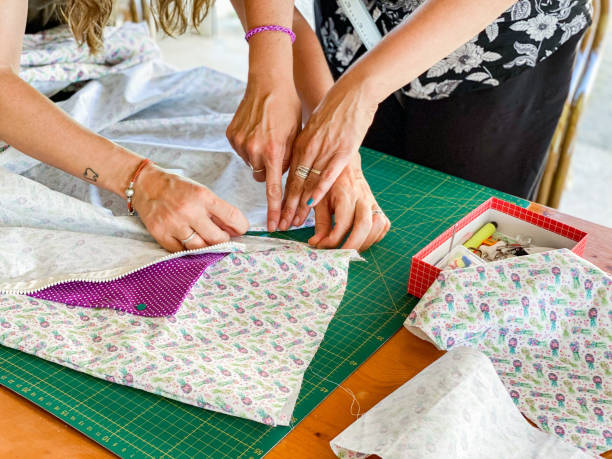 istock women on the terrace sewing with sewing machines 1323302881