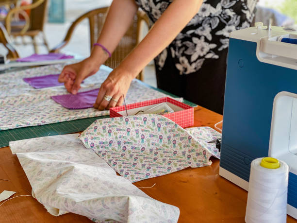 istock women on the terrace sewing with sewing machines 1323302926
