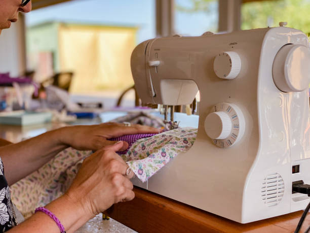istock women on the terrace sewing with sewing machines 1323302945