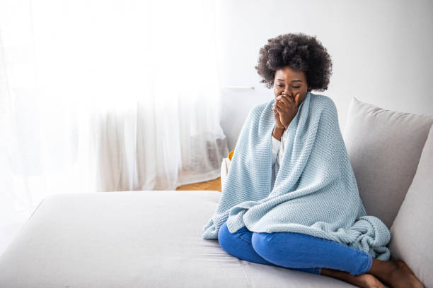 istock Woman feeling freeze and wrap up in a blanket 1323303618