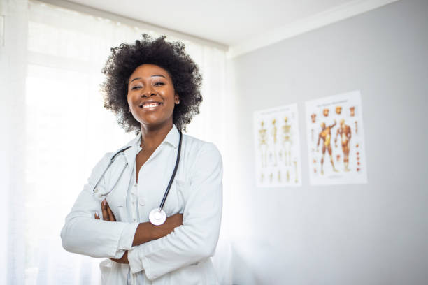 Medical Doctor Indoors Portraits. Medical Doctor Indoors Portraits. Portrait of a confident doctor working at a hospital. Waist up portrait of beautiful African-American nurse posing confidently while standing with arms crossed female nurse photos stock pictures, royalty-free photos & images