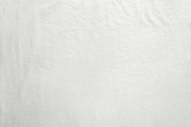 istock Off white cotton textile background. Flat lay, top view, textured textile backdrop. Copy-space, place for text 1323304602
