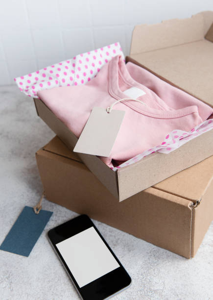 istock Clothes fir kids in an open cardboard box 1323304677