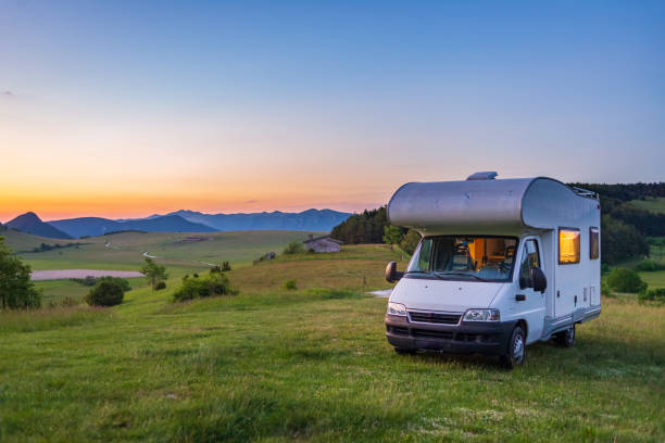 sunset clear sky over camper van in montelago highlands, marche, italy. traveling road trip in unique hills and mountains landscape, alternative vanlife vacation concept. - rv imagens e fotografias de stock