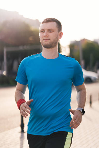 istock Attractive fit man running in the city 1323306804