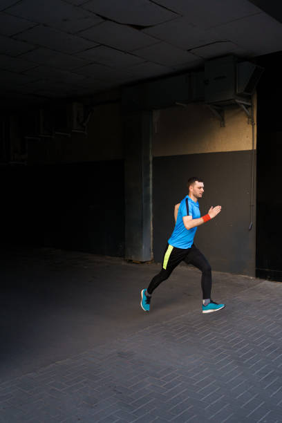istock Attractive fit man running in the city 1323307032