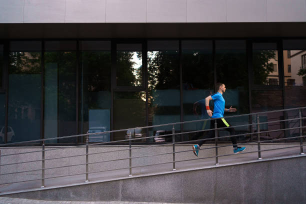 istock Attractive fit man running in the city 1323307039