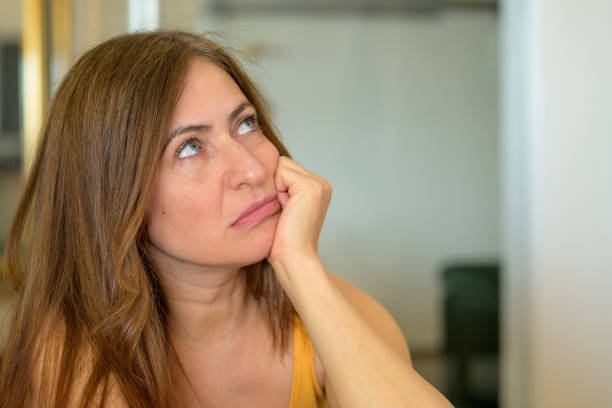 istock Troubled worried woman sitting deep in thought 1323307628