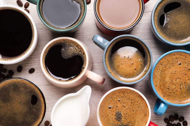 istock Many different cups of coffee and milk on white wooden table, flat lay 1323307698