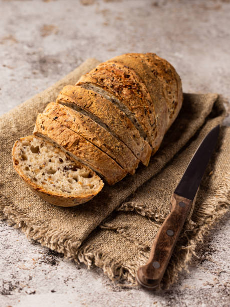 istock Sliced bread in burlap. There's a knife next to it. 1323308123