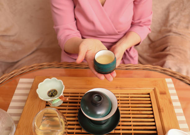 istock Master offering cup of freshly brewed tea during traditional ceremony at table, closeup 1323308251