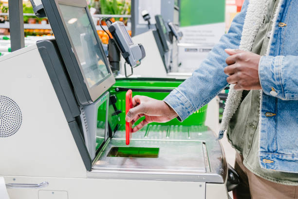 istock Black guy uses smartphone to pay at self-checkout point 1323309075
