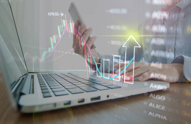 istock Business man using smart phone trade stock online with abstract graph background 1323309485