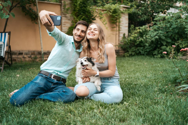 istock Young couple making selfie with their lovely dog 1323310261