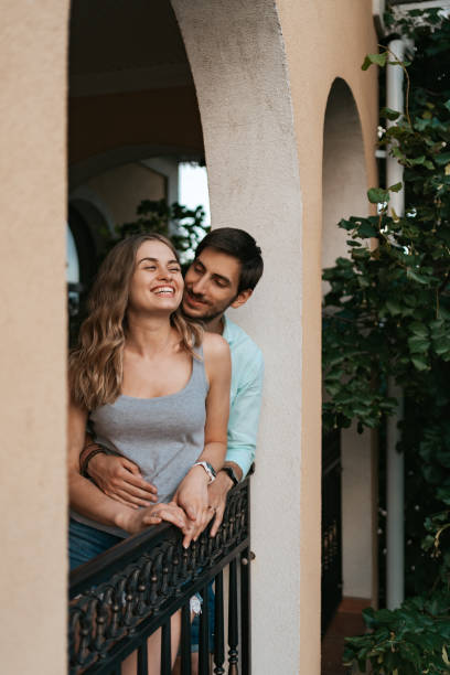 istock Portrait couple hugging on balcony 1323311059