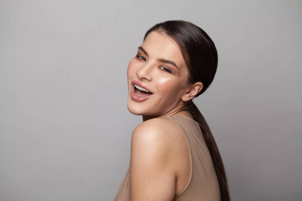 istock Happy young woman posing isolated on gray background 1323311115