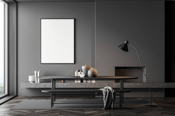 istock Grey room interior with fireplace, table and lamp, mockup poster near window 1323313731