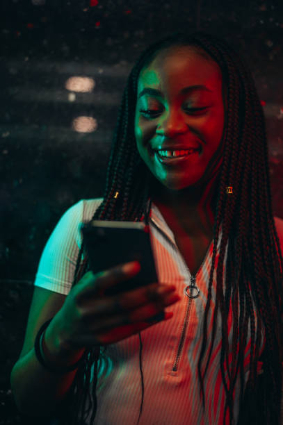 istock Cheerful african american woman using smartphone while in a subway 1323314546