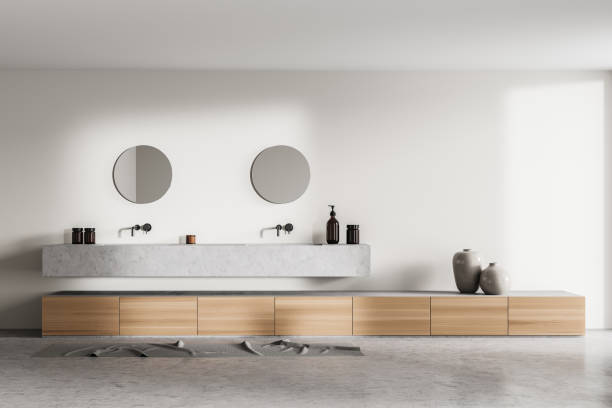 istock Bathroom interior with two sinks and mirrors with concrete floor 1323315584