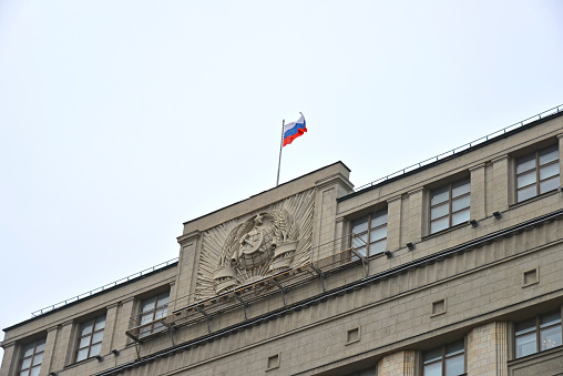 Waving flags in blue sky