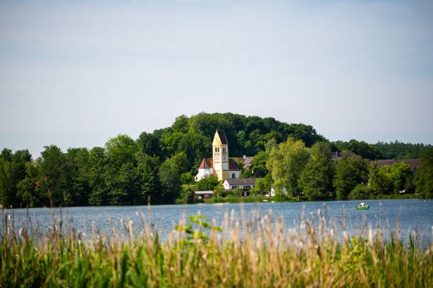istock church on Wesslinger lake, bavaria 1323317064