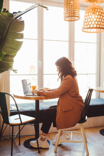 istock smiling woman freelancer in cafe with laptop 1323317209