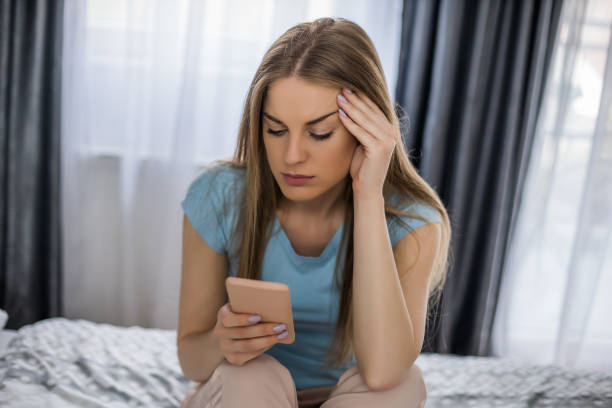 istock Sad woman holding phone 1323318040