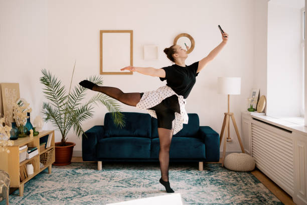 istock Woman dancing at home making photo 1323318083