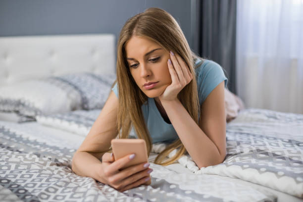 istock Sad woman holding phone 1323318227