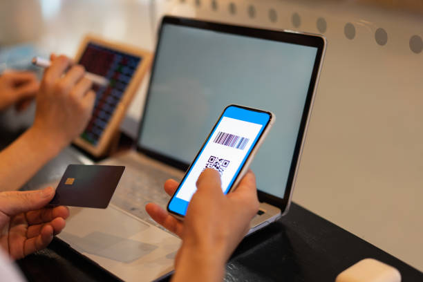 istock Close-up of man's hands using modern technology, mobile phone, tablet, laptop, credit card payment, QR code payment 1323318347