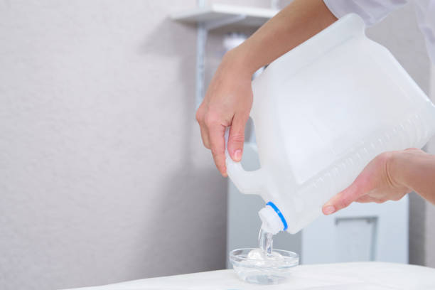 istock cosmetologist pooring transparent gel from a big bottle 1323319376