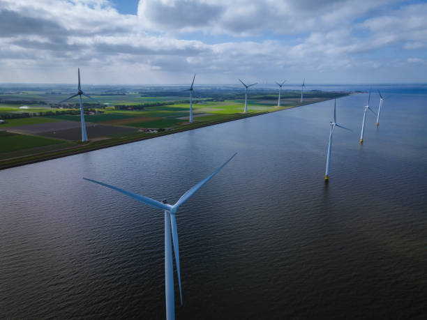 istock offshore windmill park with clouds and a blue sky, windmill park in the ocean drone aerial view with wind turbine Flevoland Netherlands Ijsselmeer 1323320681