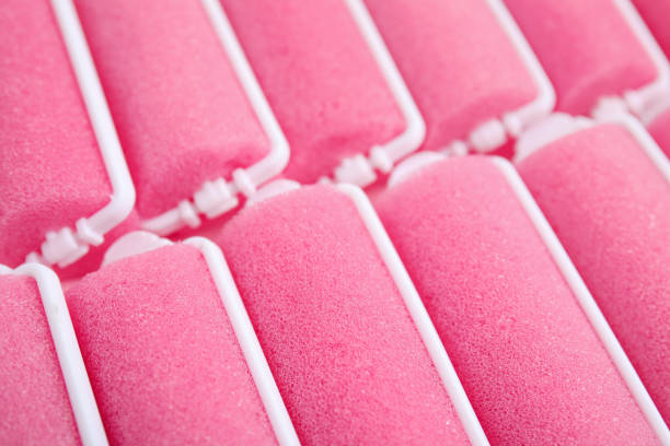 istock Many pink hair curlers as background, closeup 1323320690