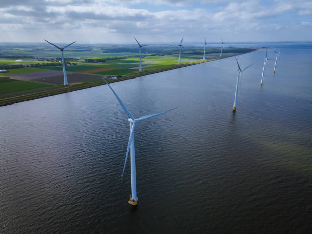 istock offshore windmill park with clouds and a blue sky, windmill park in the ocean drone aerial view with wind turbine Flevoland Netherlands Ijsselmeer 1323320896