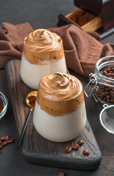 istock Refreshing Dalgona coffee in two clear glasses on a brown background 1323322200