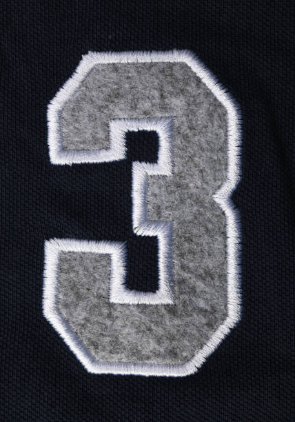 istock Numbers seven 7 and three 3 in fabric on a blue T-shirt. 1323323396