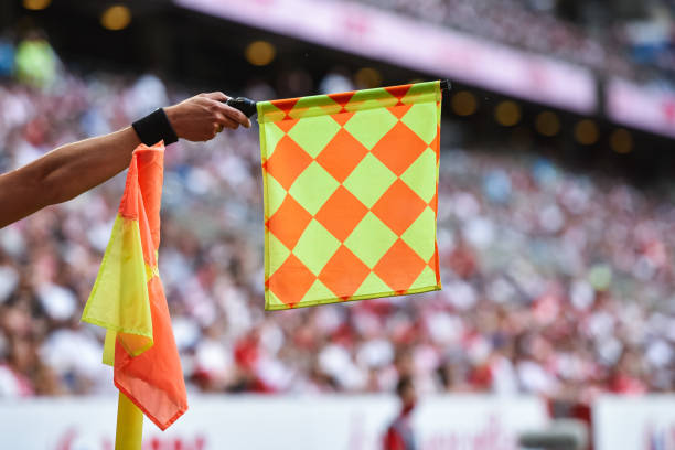 istock football referee with flag 1323326654