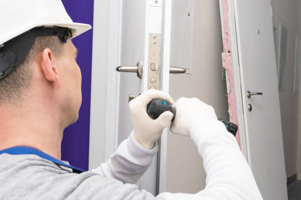 istock a worker repairs the lock at the front door 1323326923