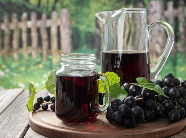 istock Glass of Grape Juice and Fresh Grapes 1323327255